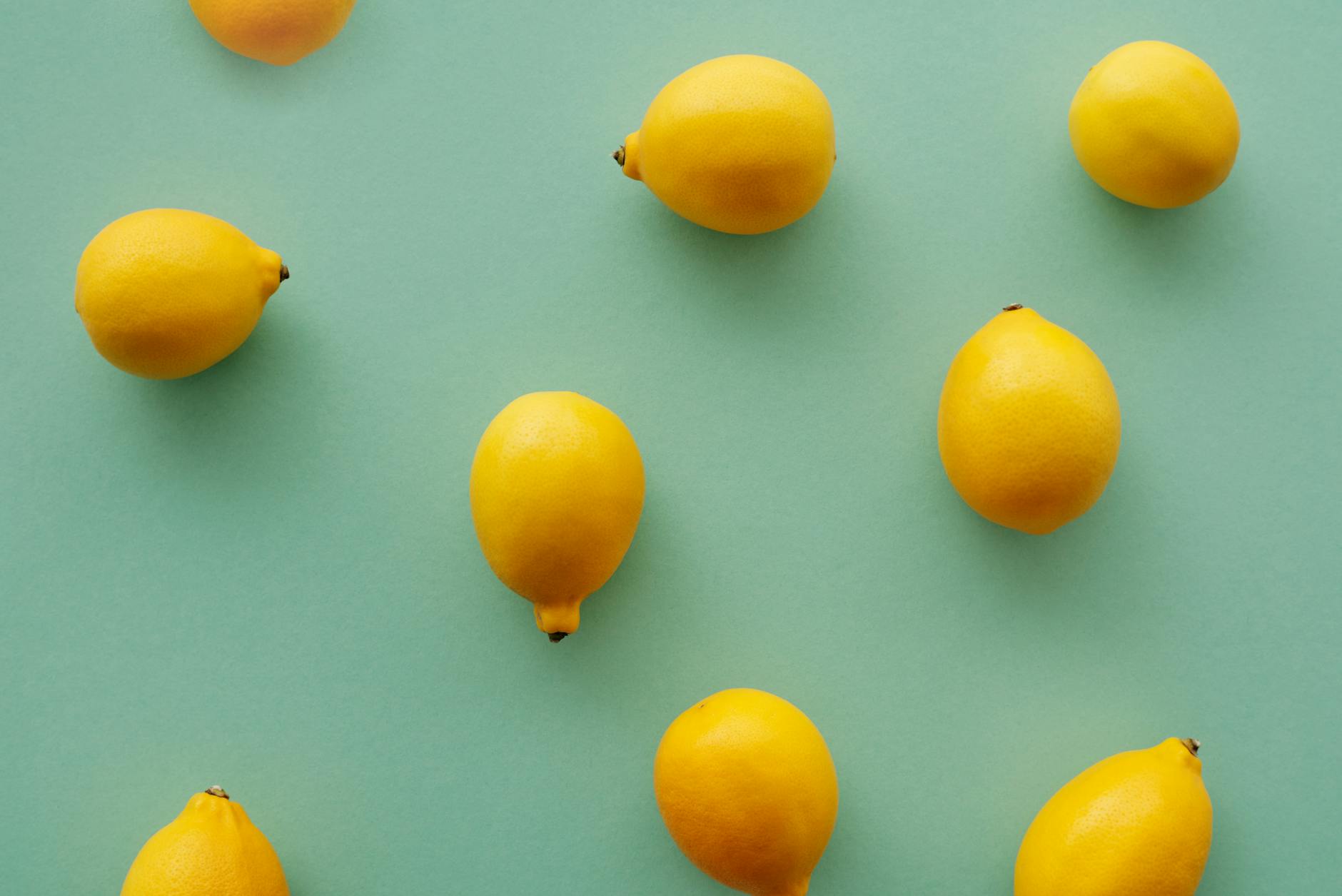 Yellow silicone vibrator surrounded by peeled bananas on a bright yellow background