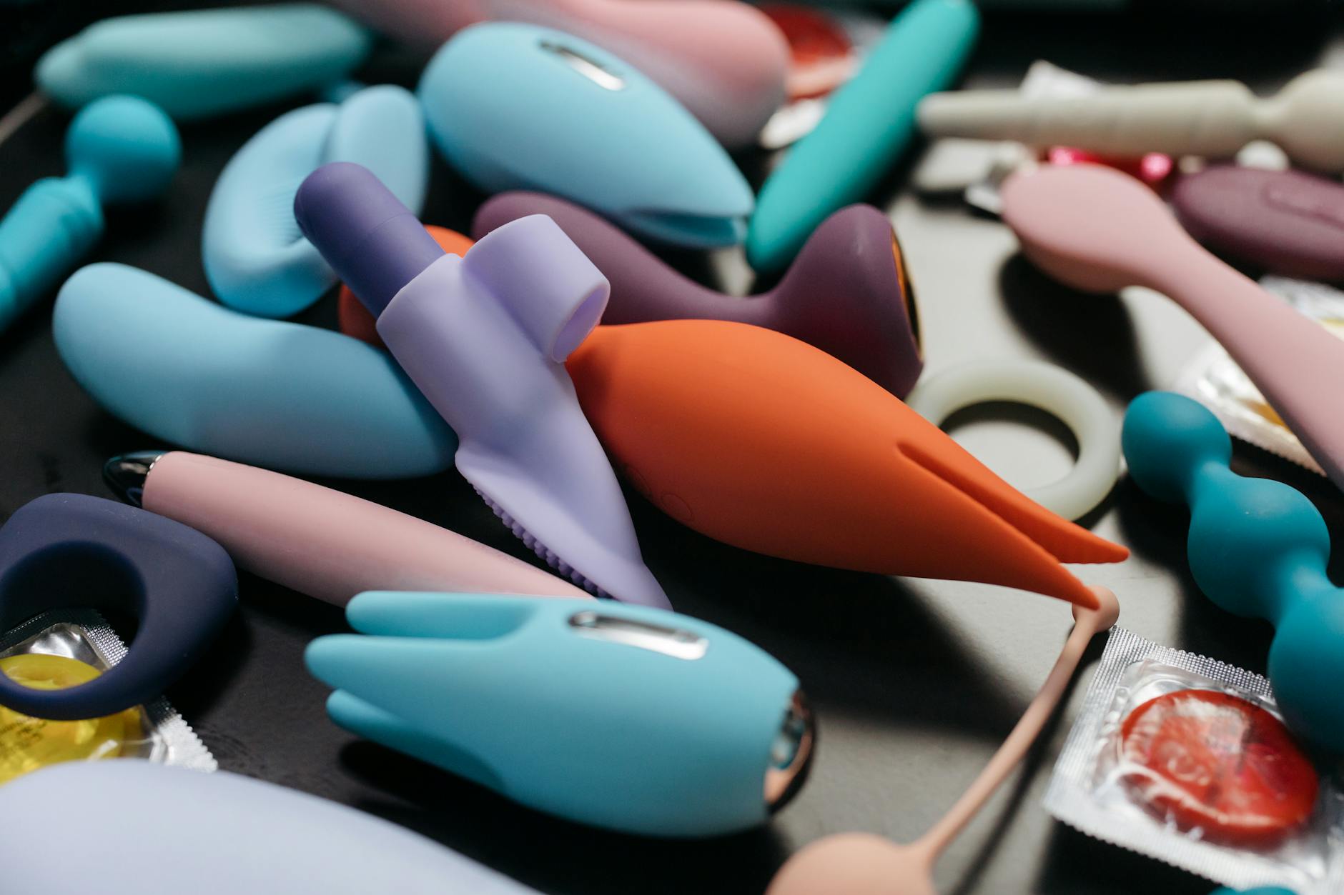 Array of vibrant clitoral vibrators and adult toys in close-up view